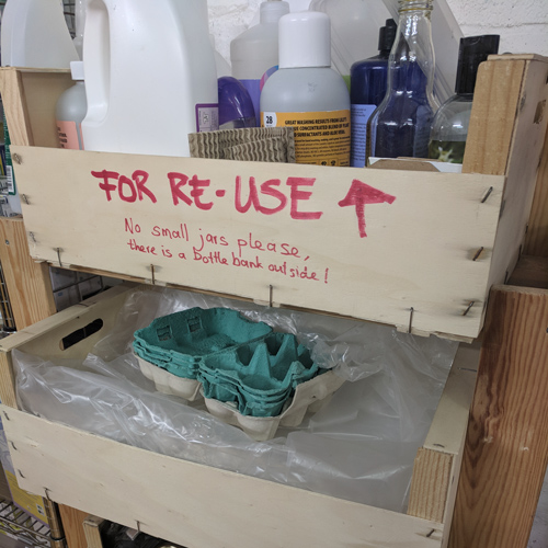 Shelf with empty jars, bottles and bags for the customers to reuse